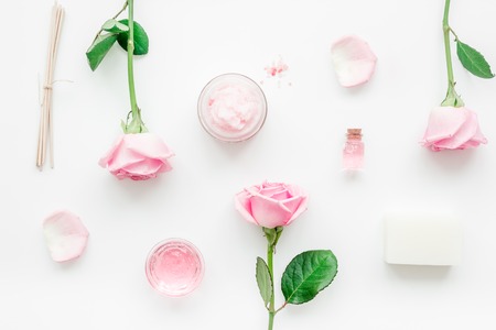 homemade spa with rose cosmetic set, cream, salt and oil on white background top viewの写真素材