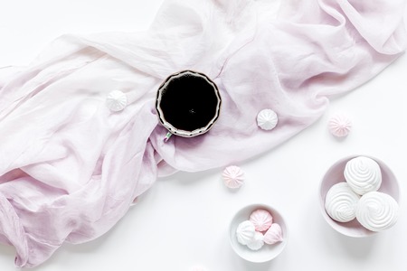light breakfast with marsh-mallow and coffee on white table background top viewの写真素材