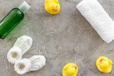 Baby care with bath cosmetic set, ducklings and towel on light gray background top view mockupの写真素材