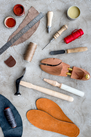 Wooden shoe with shoe tools on grey stone desk background top viewの写真素材