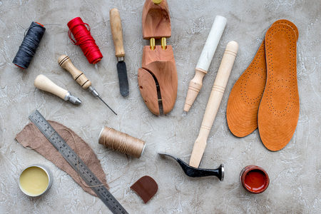 Wooden shoe with shoe tools on grey stone desk background top viewの写真素材