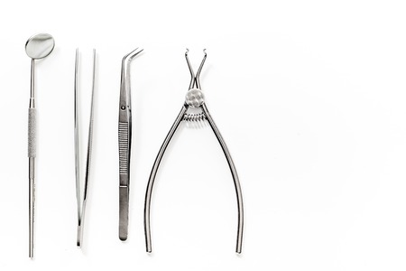dentist tools close up on white hospital desk background top view mockupの写真素材