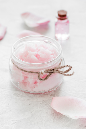 spa set with rose flowers extract and cosmetic for body on white desk backgroundの写真素材