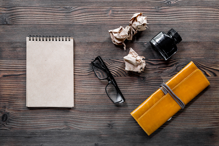 Writer acsessories. Vintage notebook, feather pen, crumpled paper on white background top view.の写真素材