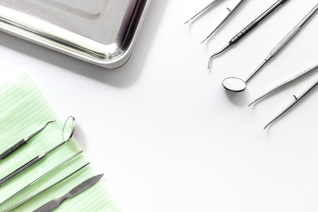 Teeth care with dentist instruments in doctor's office on white background top view mock-upの写真素材