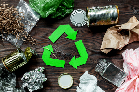 Garbage for recycling with recycling symbol on wooden background top viewの写真素材