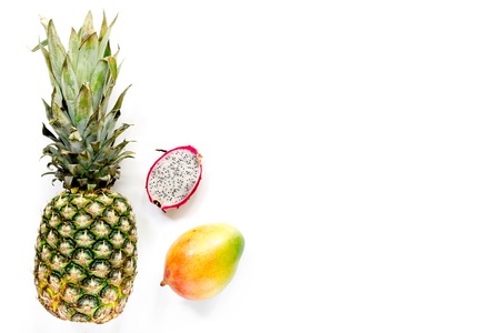 Pineapple, mango and mangosteen on white background top view copyspaceの写真素材