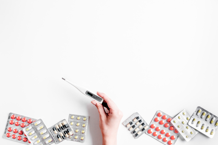 doctors work desk in hospital with stethoscope and pills white background top view mockupの写真素材