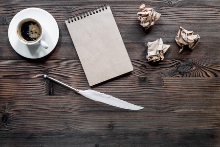 Writer concept. Feather pen, vintage notebook and crumpled paper on wooden table background top view copyspace mockupの写真素材