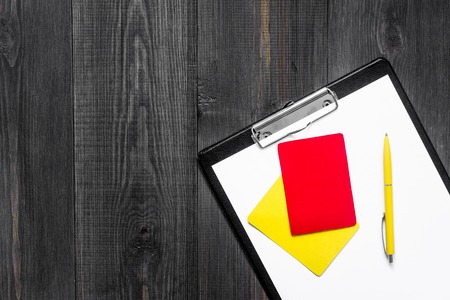 Yellow and red referee cards on wooden background top view copyspaceの写真素材