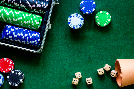 Poker set in a metallic case on a green gaming table top view.の写真素材