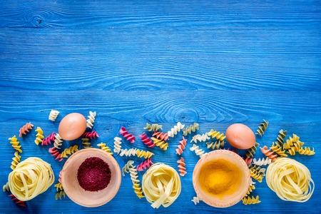Food ingredients for Italian pasta on blue wooden desk background top view copyspace.の写真素材