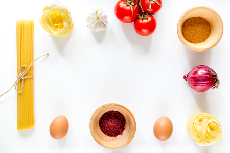 Preparing for cooking italian pasta white background top view copyspace.の写真素材