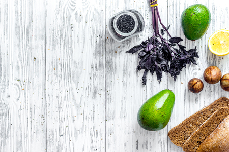 Healthy food concept. Avocado and rye bread for breakfast on wooden table background top view.の写真素材