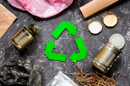 Garbage for recycling with recycling symbol on grey table background top view.の写真素材