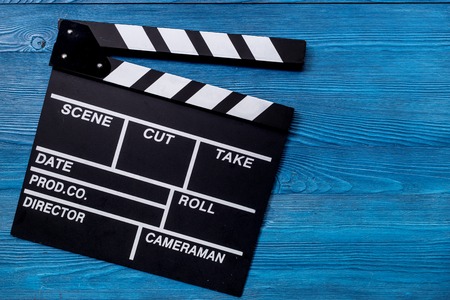 Movie clapperboard on wooden table background top view copyspace.の写真素材