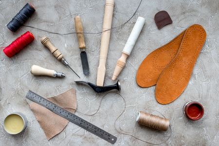 Clobber preparing his tools for work. Grey stone desk background top view.の写真素材