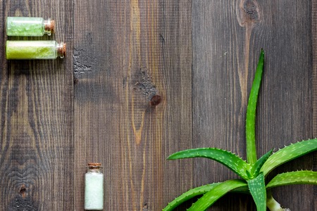 Organic aloe vera cosmetics. Aloe vera leafs and spa salt on wooden table background top view.の写真素材