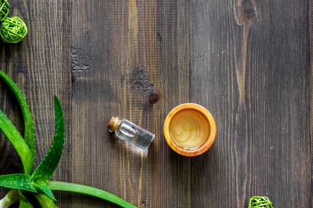 Organic aloe vera cosmetics. Aloe vera leafs and spa lotion on wooden table background top view copyspace.の写真素材