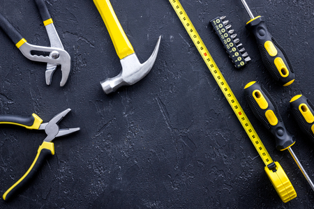 Set of construction tools on balck stone desk background top view.の写真素材