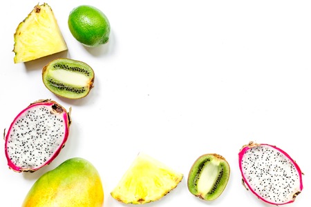 Pieces of exotic fruits. Dragonfruit, pineapple and kiwi on white background top view.の写真素材