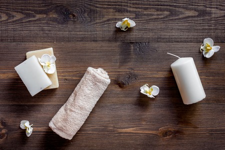 Candles and soap for aroma relax bath on wooden table background top viewの写真素材