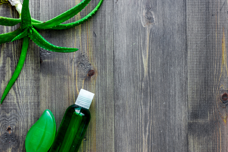 Homemade skin care. Aloe vera leafs, glass of aloe vera juice and soap on wooden table background top view.の写真素材