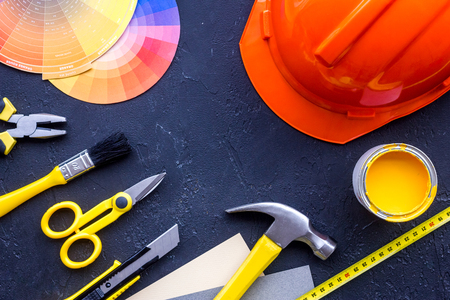Reparing home concept. Paint and tools on black stone desk background top view copyspaceの写真素材