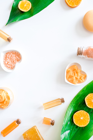 Aroma spa set. Citrus scrub, salt and lotion on white background top view copyspaceの写真素材
