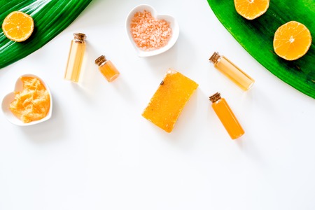 Aroma spa set. Citrus scrub, soap, salt and lotion on white background top view.の写真素材