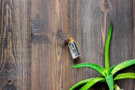 Organic aloe vera cosmetics. Aloe vera leafs and spa oil on wooden table background top view copyspaceの写真素材