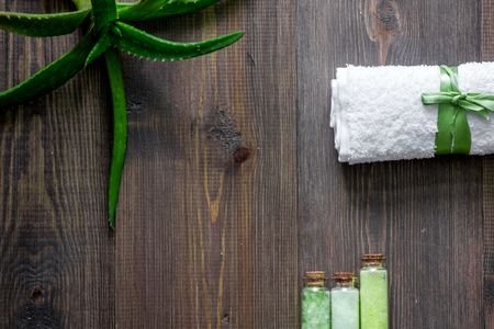 Organic aloe vera cosmetics. Aloe vera leafs and spa salt on wooden table background top view copyspaceの写真素材