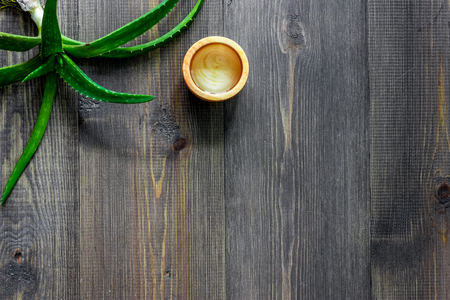 Skin care. Aloe vera gel and aloe vera leafs on wooden background top view copyspaceの写真素材