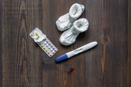 Pregnancy planning. Wooden table background top view.の写真素材