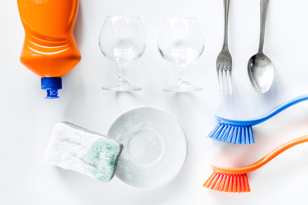 Wash dishes. Tableware, liquid and brushes on white background top viewの写真素材