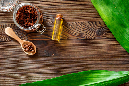 Skin care. Coffee scrub on wooden background top view copyspaceの写真素材