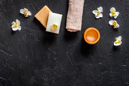 Relax concept. Handmade organic soap and gel on black stone table background top view.