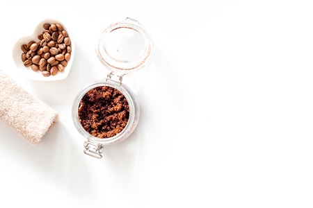 Spa treatment. Coffee scrub on white background top view.