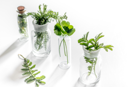 Homeopathy. Medicinal herbs in glass on white background.の写真素材