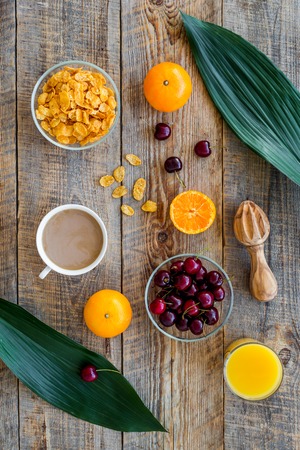 Light summer breakfast. Muesli, fruits and berries on wooden table background top view.の写真素材