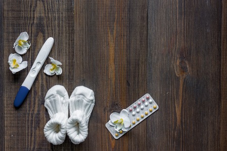 Pregnancy planning. Wooden table background top view.の写真素材