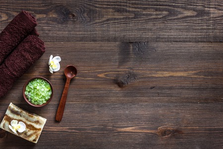 Relax concept. Handmade organic soap and bath salt on wooden table background top view.の写真素材