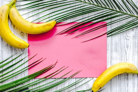 Banana and palm branch on wooden table background top view mockup.の写真素材