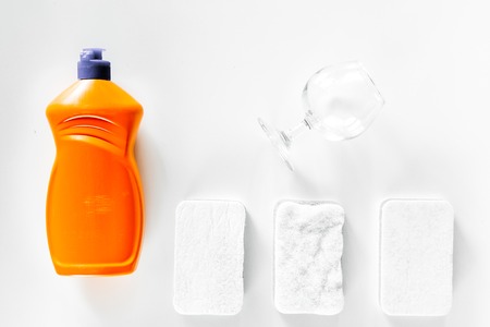 Dishwashing liquid and sponge on white background top view.の写真素材