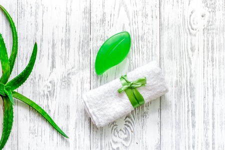 Natural herbal skin care. Aloe vera leafs and soap on wooden table background top view.の写真素材