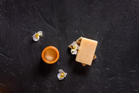 Relax concept. Handmade organic soap and gel on black stone table background top view.の写真素材
