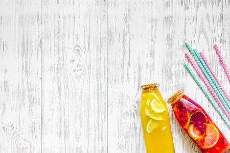 Bottle with fresh lemonade on wooden background top viewの写真素材