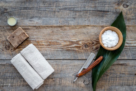 Barber workplace. Shaving foam and razor on wooden table background top view.の写真素材