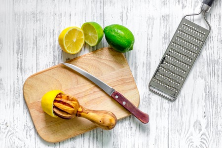 Preparing lemonade. Lemon, lime, grater on wooden background top viewの写真素材