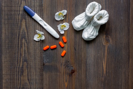Pregnancy planning. Wooden table background top view.の写真素材